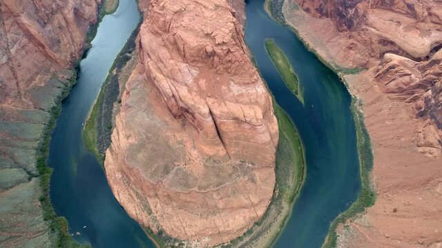 Breathtaking panoramic aerial of deep-blue river curving around beautiful high red cliff of world famous American landmark - Horseshoe bend park in Arizona. 4K slow motion, travel, abstract background