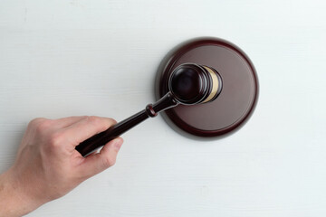 Hand knocking the table with a judge hammer