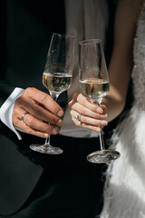 Glasses of champagne in hands. Bride and groom. Wedding