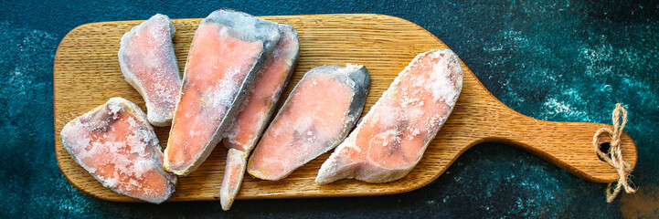 pink salmon steak frozen raw fish seafood in ice quick freeze. food background top view copy space...