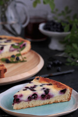 Homemade Blueberry Custard Pie. A piece of Blueberry Tart on a plate. 