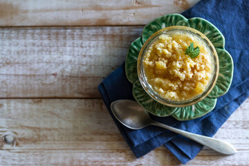 Delicious brazilian ambrosia sweet on white wooden background