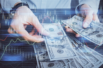 Multi exposure of financial graph drawing hologram and USA dollars bills and man hands. Analysis concept.