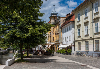 Fototapeta premium open-air restaurant near the river in the old town