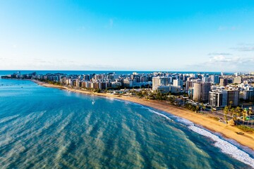 Obraz premium Aerial breathtaking shot of the cityscape with a calm ocean