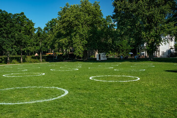 Circels on the lawn in a park. Social distancing. Covid19  Corona Rotterdam.