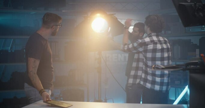 Costumer choosing light in video equipment store