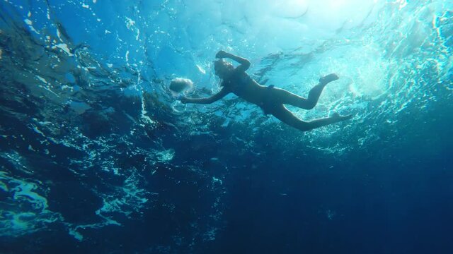 Girl collects Dirt and Garbage 
Underwater shoot of a dirty discarded plastic bottle floating in the sea
Teenager Catches Trash from the Water
4k