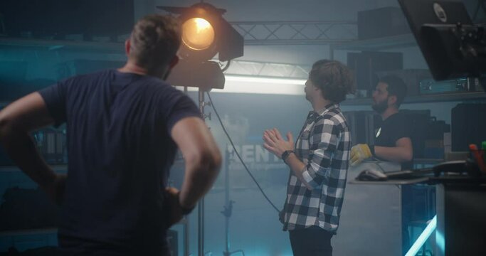Costumer choosing light in video equipment store