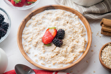 oatmeal with berries in wood bowl