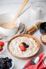 oatmeal with berries in wood bowl