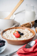 oatmeal with berries in wood bowl
