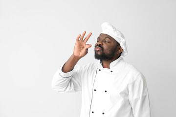 Male African-American chef on white background