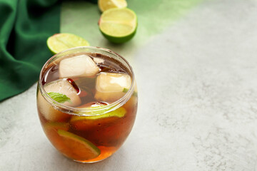 Glass of tasty Cuba Libre cocktail on table