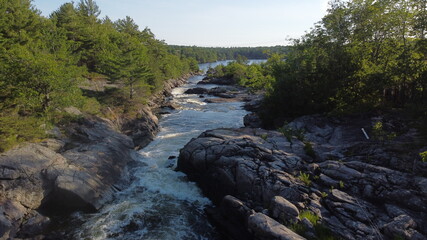 Naklejka na ściany i meble Panoramic Scenic View of Rapids in Muskoka, Ontario with fast-flowing river in nature landscape