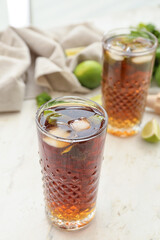 Glasses of tasty Cuba Libre cocktail on table