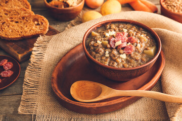 Bowl of tasty lentils soup on table