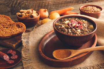 Bowl of tasty lentils soup on table