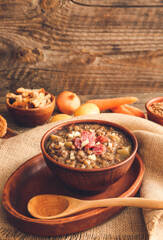 Bowl of tasty lentils soup on table