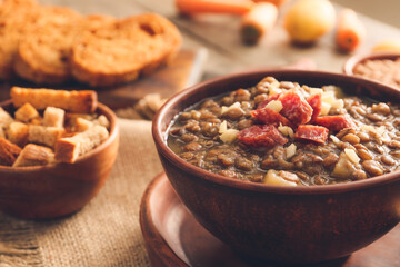 Bowl of tasty lentils soup on table, closeup