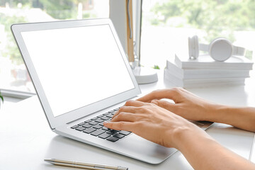 Woman using laptop at table in room