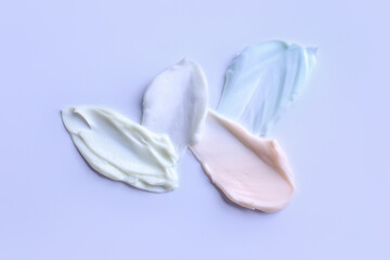 Samples of cream on color background