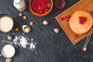 Composition with ingredients for pancakes on dark background