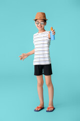 Fototapeta na wymiar Little boy with sun protection cream on color background