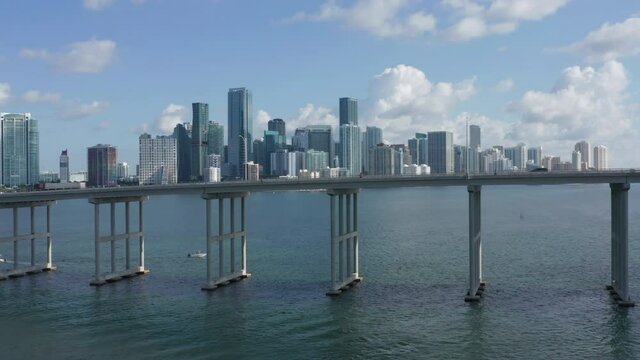 High bridge over the Miami bay area, Florida, USA. Drone flight above the bay area highway with rush hour traffic. 4K aerial panorama of Miami Business District. Financial center at daytime. Summer.