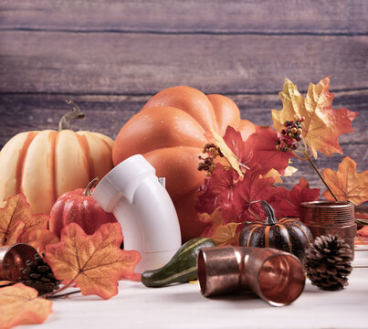 Happy Thanksgiving with construction tools, maple leaves and pumpkin on wood background.
Autumn composition with copy space. Plumber Thanksgiving. 