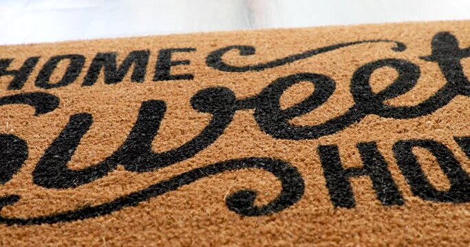 4k Pan Over Home Sweet Home Welcome Mat Resting on Floor