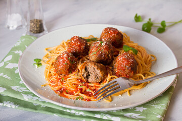 Meatballs and pasta with tomato sauce on plate. horizontal image