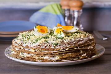 Layered liver cake with cheese, mayonnaise and dill