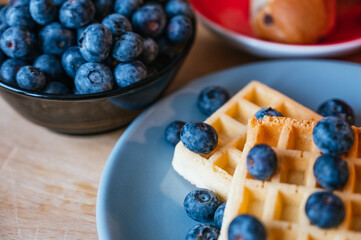 Healthy breakfast of waffles with blackberries, coffee and croissant