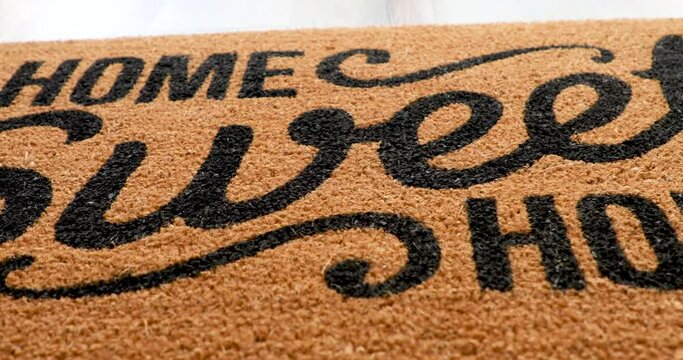 4k Pan Over Home Sweet Home Welcome Mat Resting on Floor