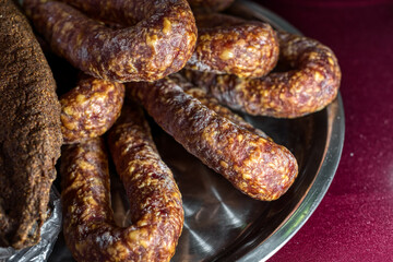 Fototapeta premium Smoked sausages lie on a large dish.