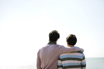 Man putting arm around his friend