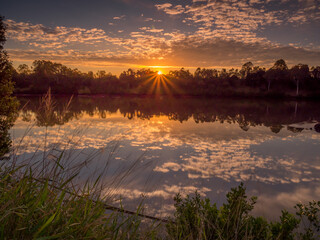 Beautiful Riverside Sunrise with Sunburst