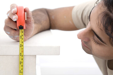 Man measuring mantelpiece with a tape measure