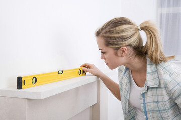 Woman using spirit level