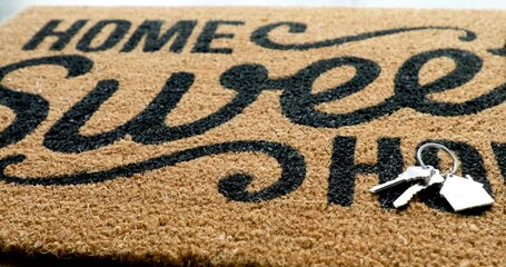 4k Pan Over Home Sweet Home Welcome Mat with House Key Ring Resting on Floor