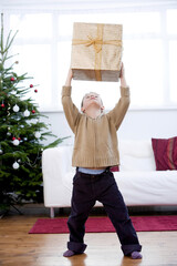 Little boy lifting a present