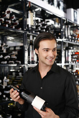 Man choosing a bottle of wine from the wine cellar