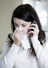 A woman with cold on the phone