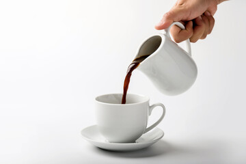pouring a cup of coffee over white background