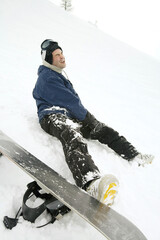 Male snowboarder with injured leg