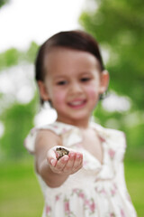Girl with a frog on her palm