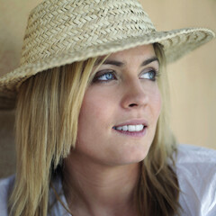 Woman in straw hat looking away