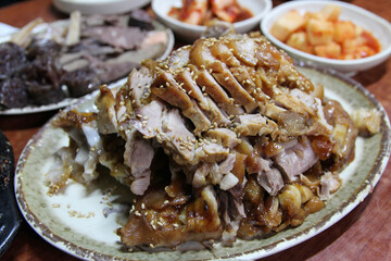 Focus on the Korean style braised pork belly with the side dishes at Korean restaurant, Seoul, South Korea