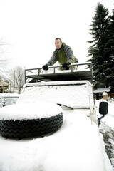 Man climbing to the top of vehicle